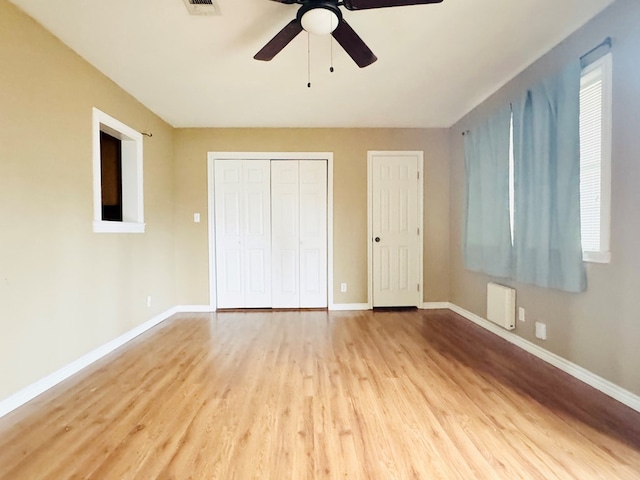 unfurnished bedroom featuring ceiling fan and light wood-type flooring