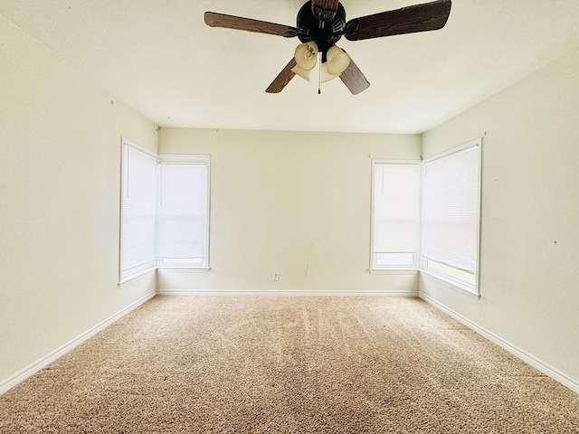 empty room with ceiling fan and carpet floors