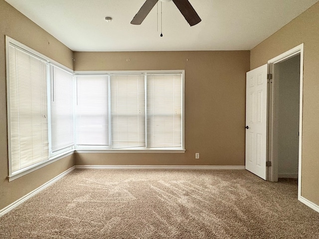 empty room with carpet floors and ceiling fan