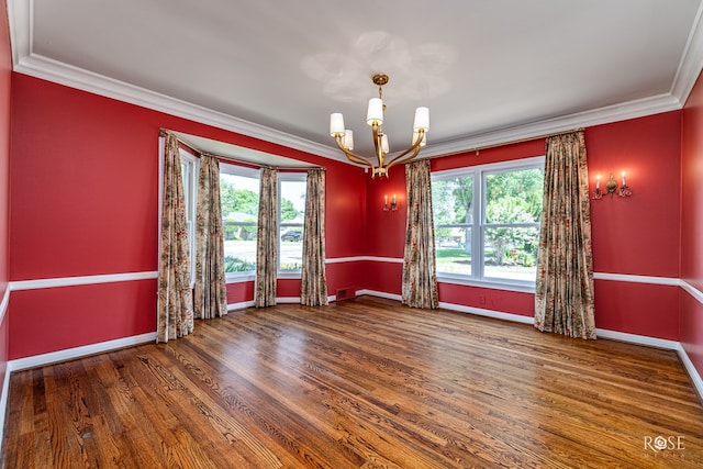 1322 S Monroe St, San Angelo, TX 76901 - empty room featuring a chandelier, crown molding, healthy amount of natural light, and baseboards
