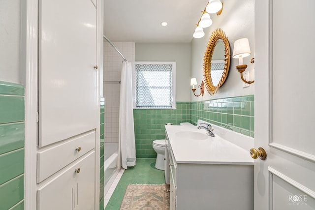 1322 S Monroe St, San Angelo, TX 76901 - bathroom with vanity, tile walls, tile patterned floors, toilet, and shower / bath combination with curtain