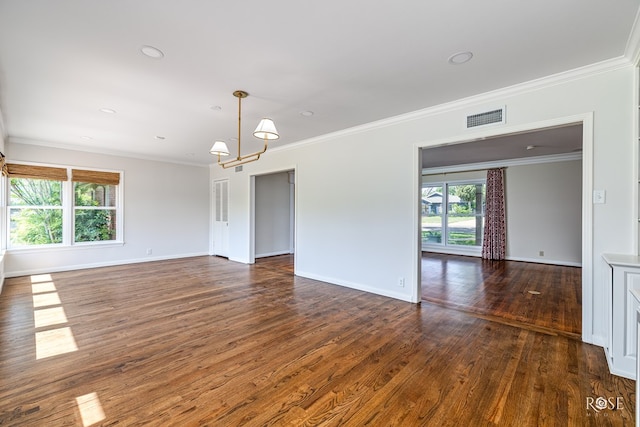 1322 S Monroe St, San Angelo, TX 76901 - empty room with dark wood-type flooring, a chandelier, baseboards, and ornamental molding