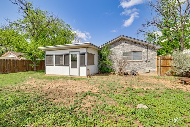 3109 College Hills Cir, San Angelo, TX 76904 - back of house featuring a sunroom, a fenced backyard, and brick siding