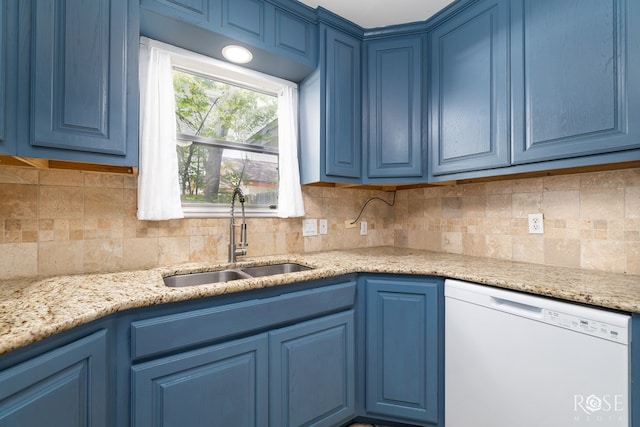 3109 College Hills Cir, San Angelo, TX 76904 - kitchen with white dishwasher, blue cabinetry, decorative backsplash, and light stone countertops