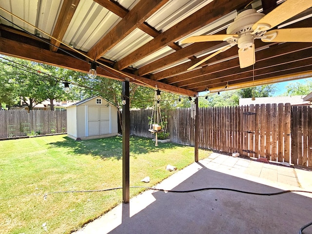 view of patio with ceiling fan and a storage shed