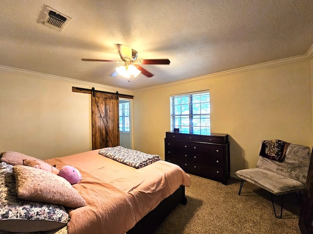 bedroom with crown molding, a barn door, carpet flooring, and ceiling fan