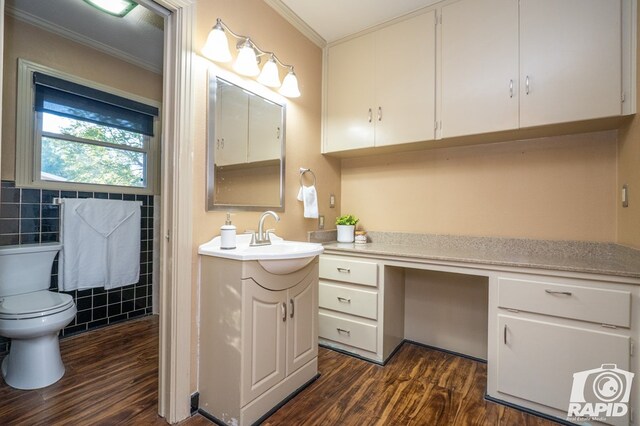 bathroom with crown molding, vanity, toilet, and hardwood / wood-style floors