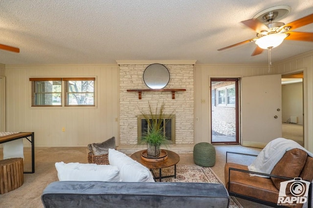 living room with light carpet, a brick fireplace, a wealth of natural light, and ceiling fan