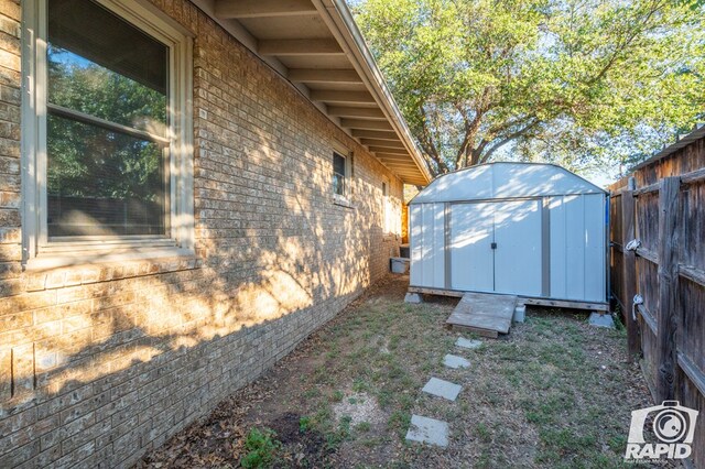 view of side of property with a storage shed