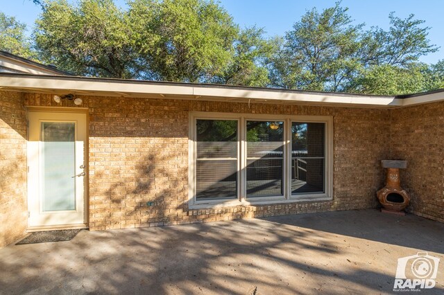 entrance to property featuring a patio