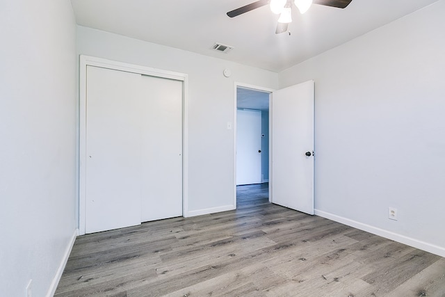 2021 Field Ave, San Angelo, TX 76901 - unfurnished bedroom with wood finished floors, baseboards, a closet, and a ceiling fan