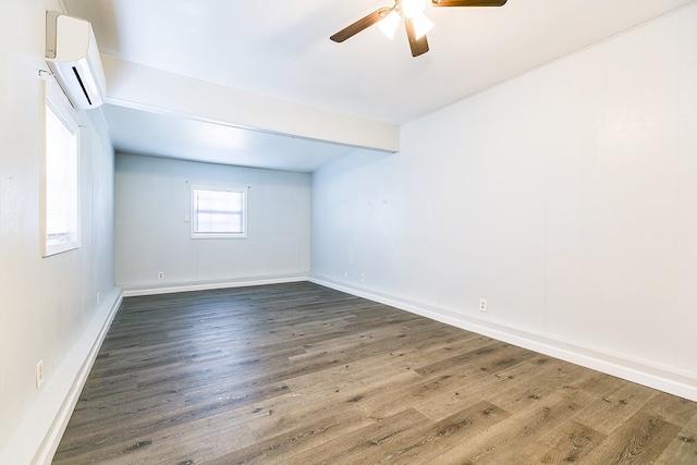 2021 Field Ave, San Angelo, TX 76901 - spare room with an AC wall unit, a ceiling fan, wood finished floors, and baseboards