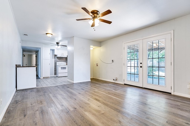 2021 Field Ave, San Angelo, TX 76901 - unfurnished living room with ceiling fan, french doors, light wood-type flooring, and baseboards