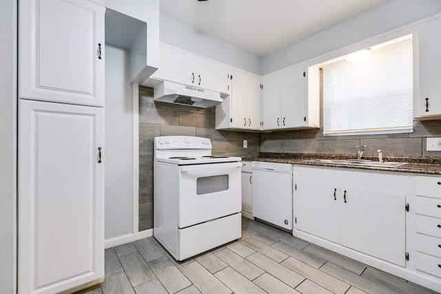 2021 Field Ave, San Angelo, TX 76901 - kitchen featuring white appliances, under cabinet range hood, a sink, dark countertops, and tasteful backsplash