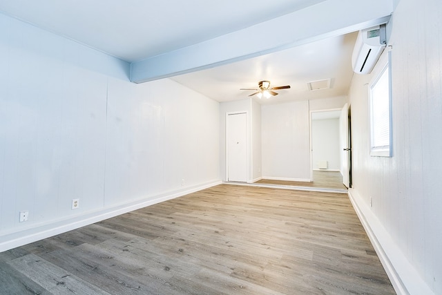 2021 Field Ave, San Angelo, TX 76901 - unfurnished room featuring a wall mounted air conditioner, wood finished floors, and baseboards