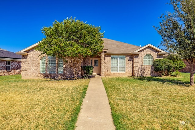 ranch-style home featuring a front yard