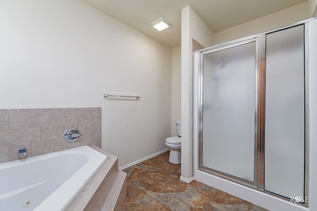 bathroom featuring toilet and independent shower and bath