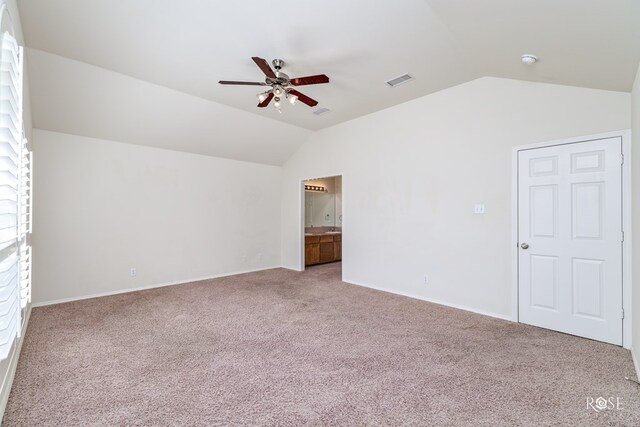 unfurnished room with ceiling fan, vaulted ceiling, and carpet