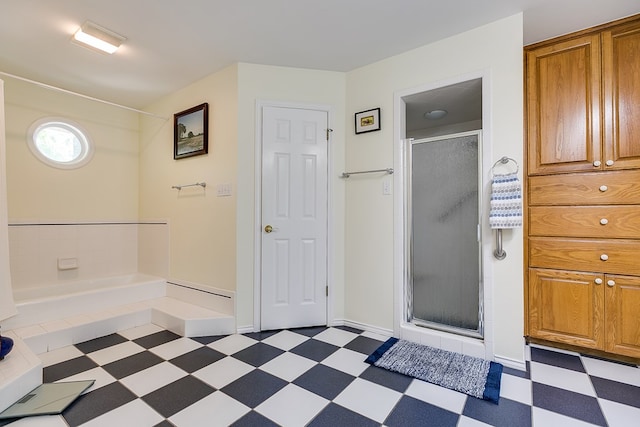 bathroom featuring a shower with shower door