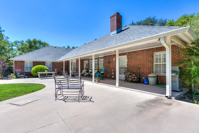 back of house with a patio