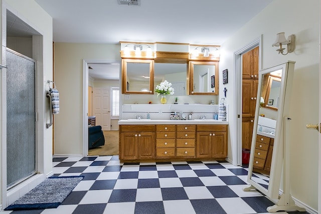 bathroom featuring vanity and a shower with door