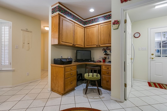 office with light tile patterned flooring and built in desk