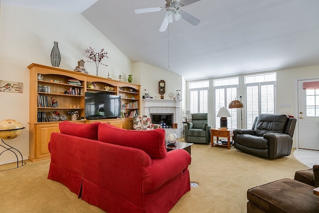 carpeted living room with lofted ceiling, a fireplace, and ceiling fan