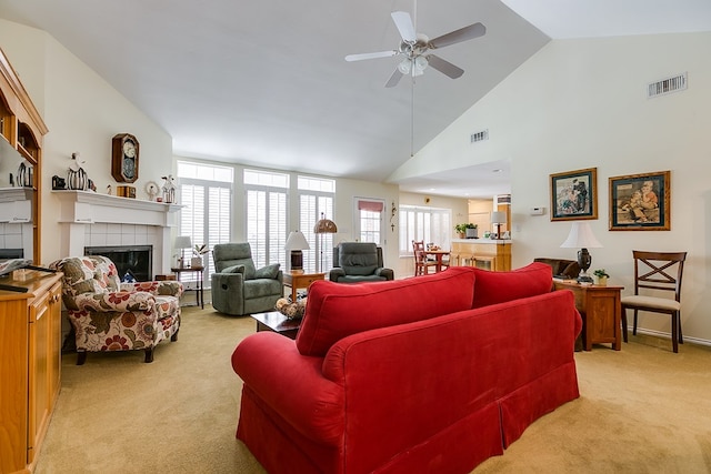 living room featuring a fireplace, light colored carpet, and a healthy amount of sunlight