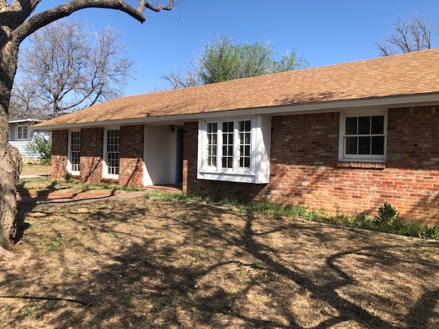 view of front of home featuring brick siding