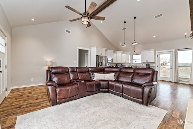 living room featuring ceiling fan, dark hardwood / wood-style floors, and high vaulted ceiling