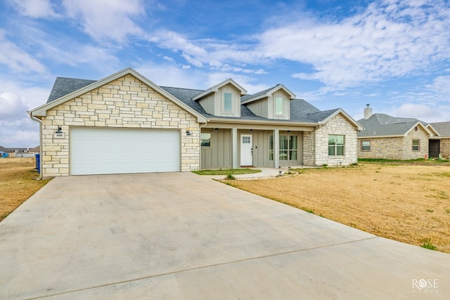 view of front of house with a garage and a front lawn