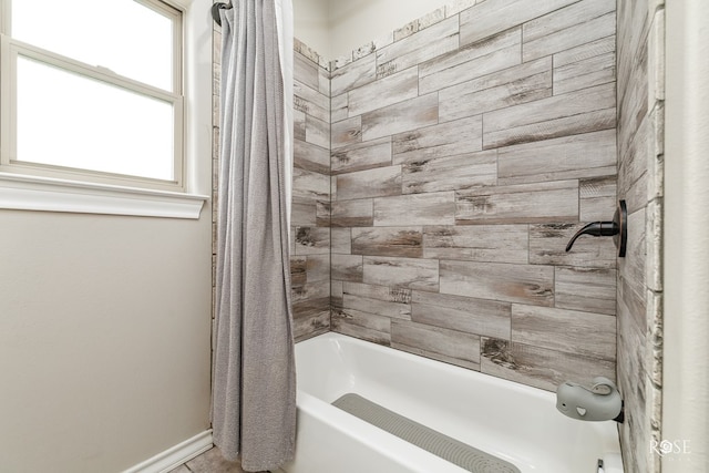 bathroom featuring shower / bathtub combination with curtain