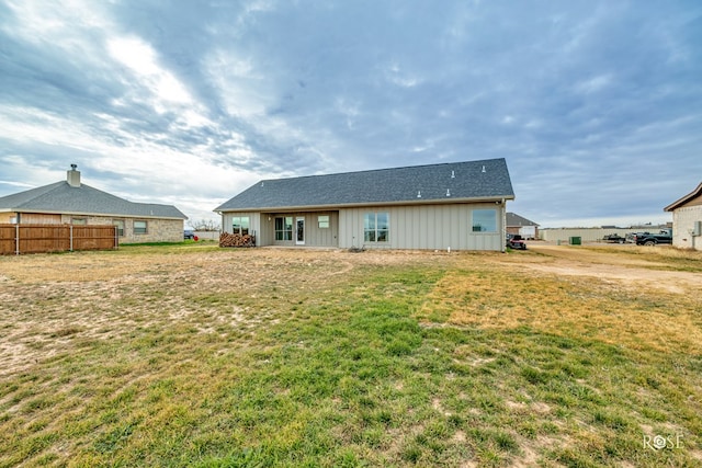 rear view of house with a yard