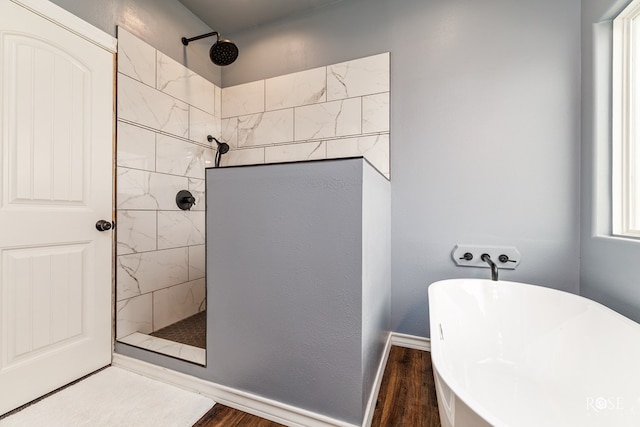 bathroom with independent shower and bath and hardwood / wood-style floors