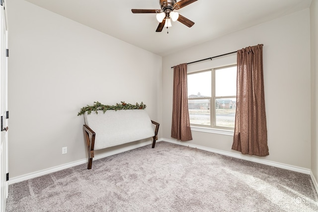 living area with ceiling fan and light carpet