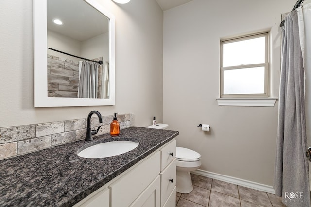 bathroom featuring tile patterned flooring, vanity, and toilet