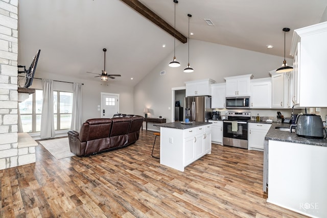 kitchen featuring light hardwood / wood-style flooring, stainless steel appliances, a center island, white cabinets, and decorative light fixtures