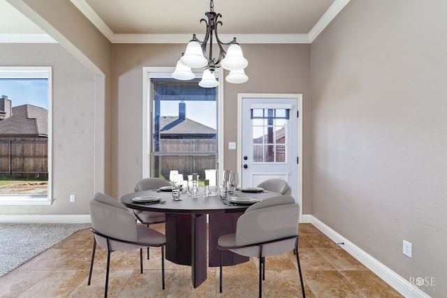 dining space with ornamental molding and a notable chandelier