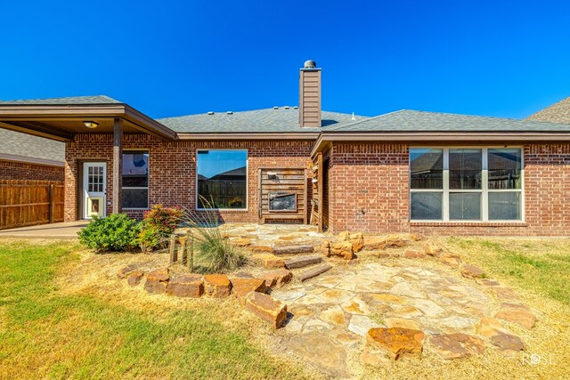 back of house featuring a yard and a patio