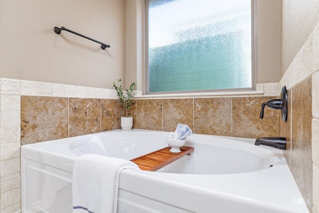 bathroom with a tub to relax in