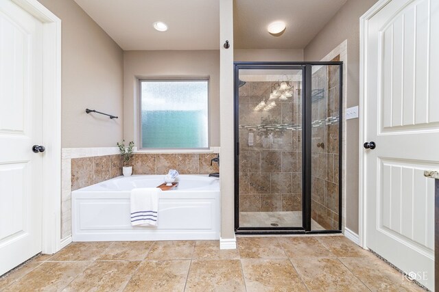 bathroom featuring separate shower and tub