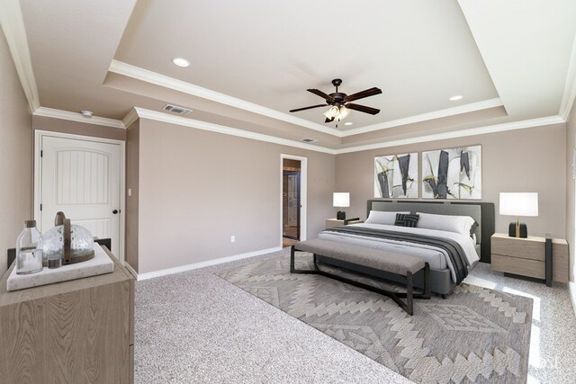 carpeted bedroom with crown molding, ceiling fan, and a tray ceiling