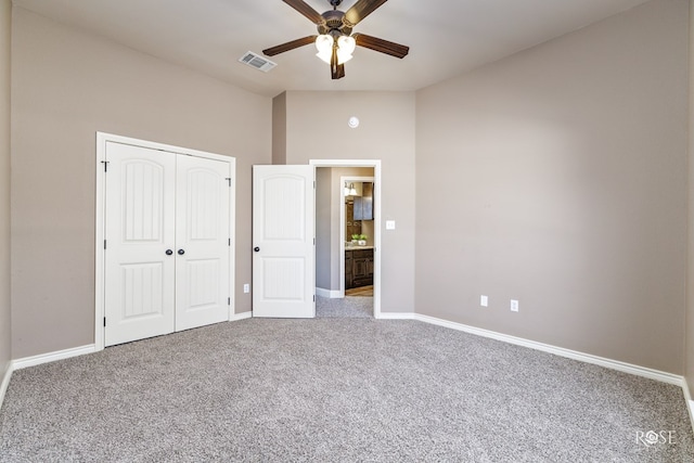 unfurnished bedroom featuring light carpet, ceiling fan, and a closet