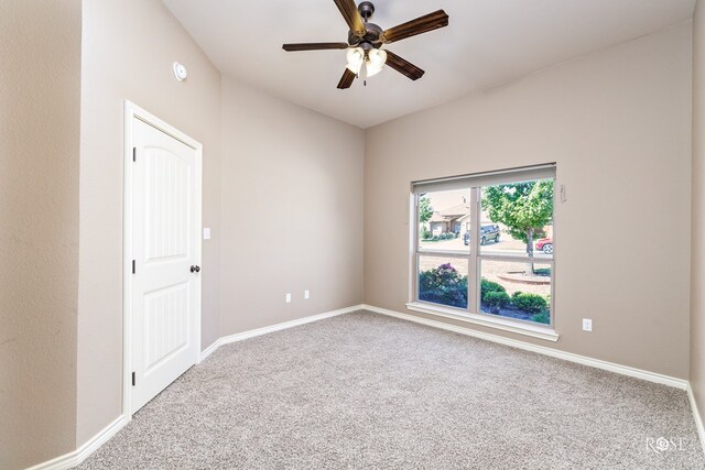 carpeted spare room with ceiling fan