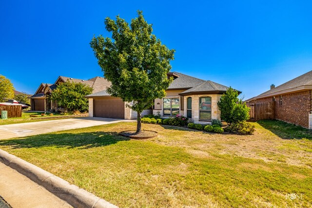 view of front of house with a garage and a front yard