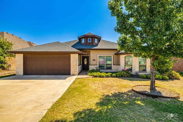 prairie-style house with a garage and a front lawn