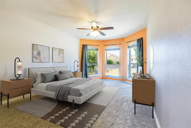 carpeted bedroom featuring multiple windows and ceiling fan