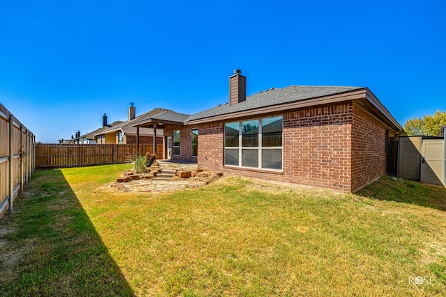 rear view of house featuring a yard