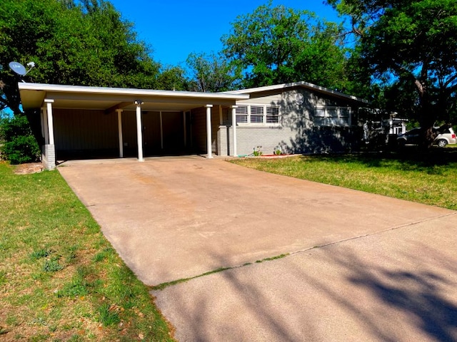 ranch-style home with a carport and a front yard