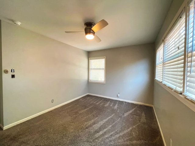 carpeted spare room with ceiling fan